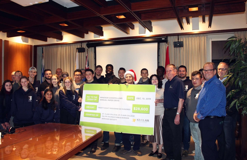 Students presenting cheque to Windsor Goodfellows