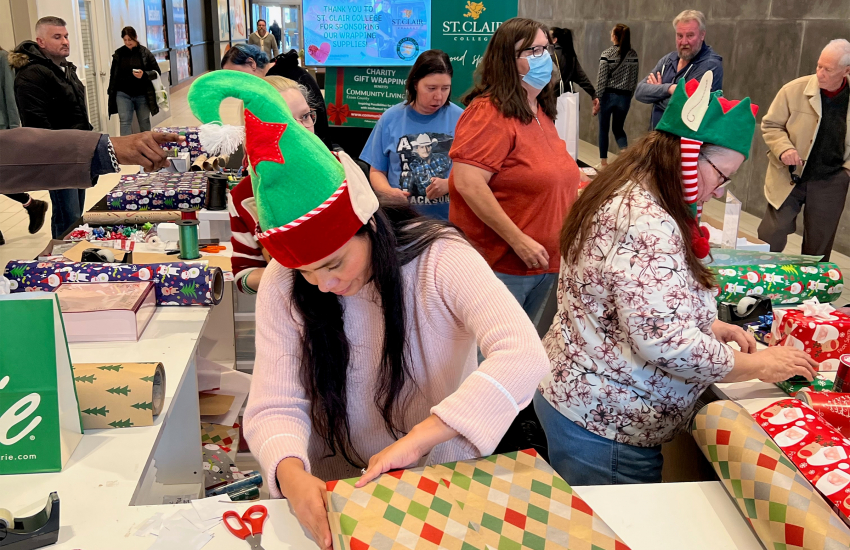 Volunteers wrapping gifts at mall