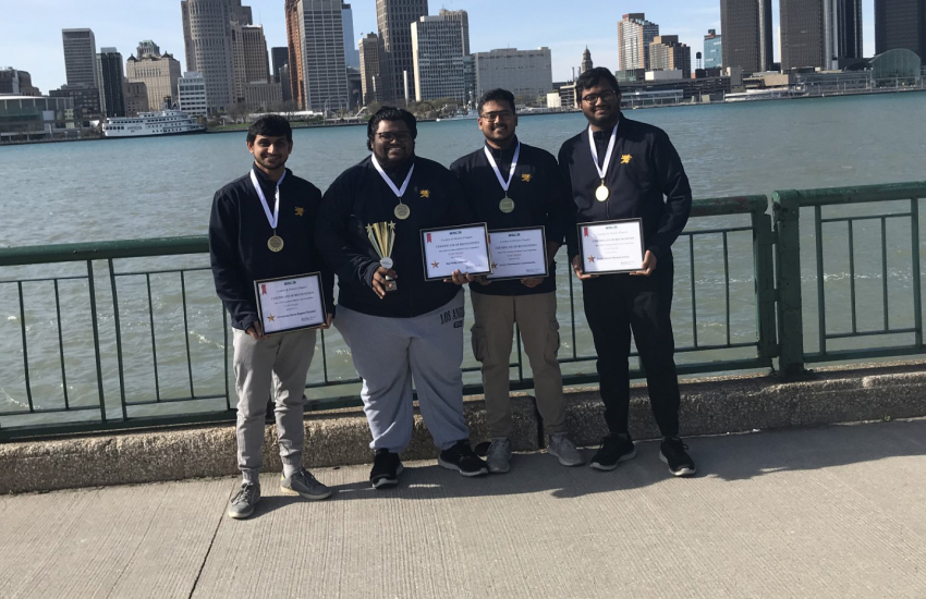 First place winners in front of Detroit river