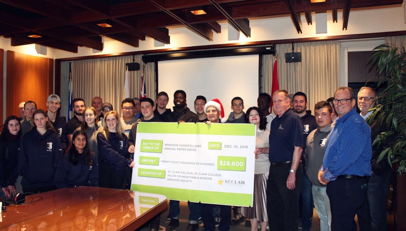 Students presenting cheque to Windsor Goodfellows
